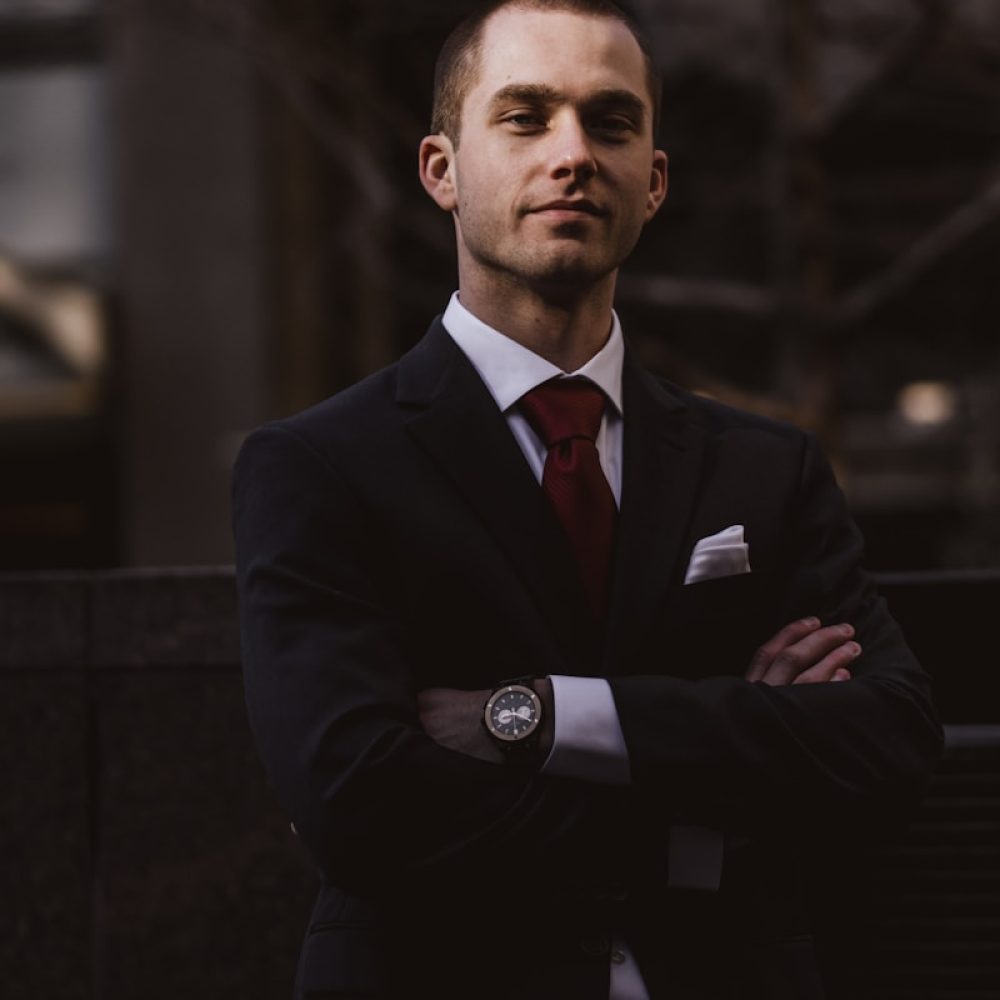Photo by Ali Morshedlou man wearing black notched lapel suit jacket in focus photography
